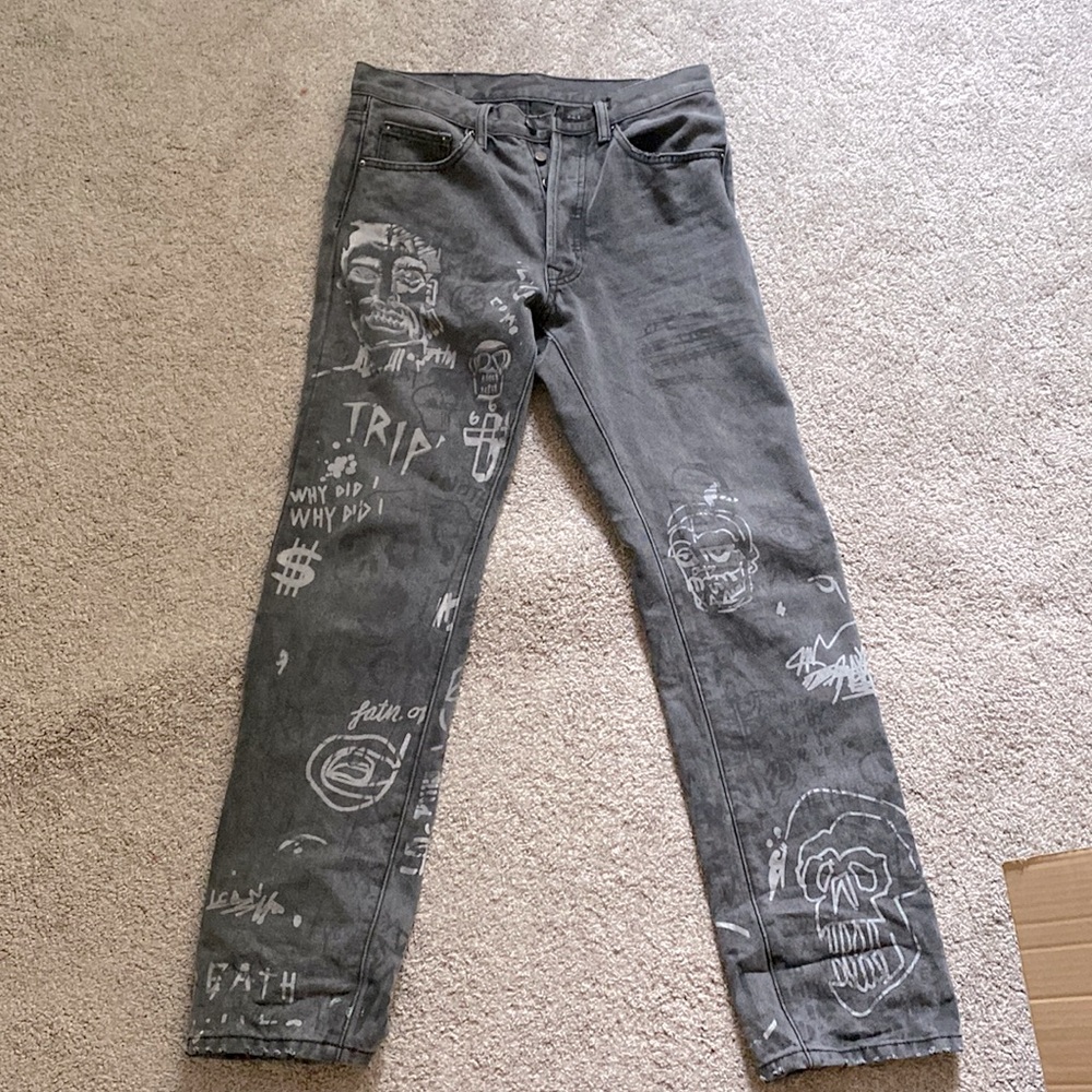 Black baggy jeans with a design printed on them done by Terry Urban.
